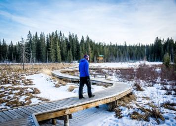 Man walking along boardwalk in Hinton