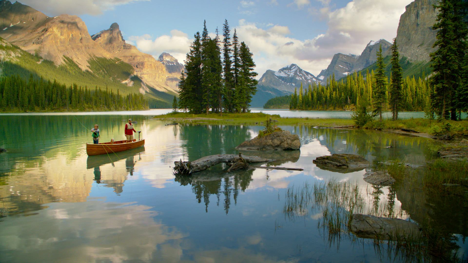 Father and son fishing in a canoe on Maligne Lake