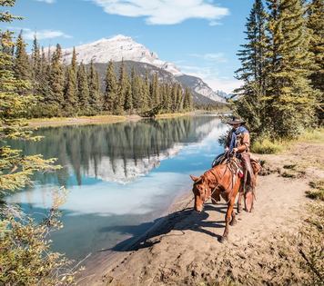 Trail riding along a river in banff national park