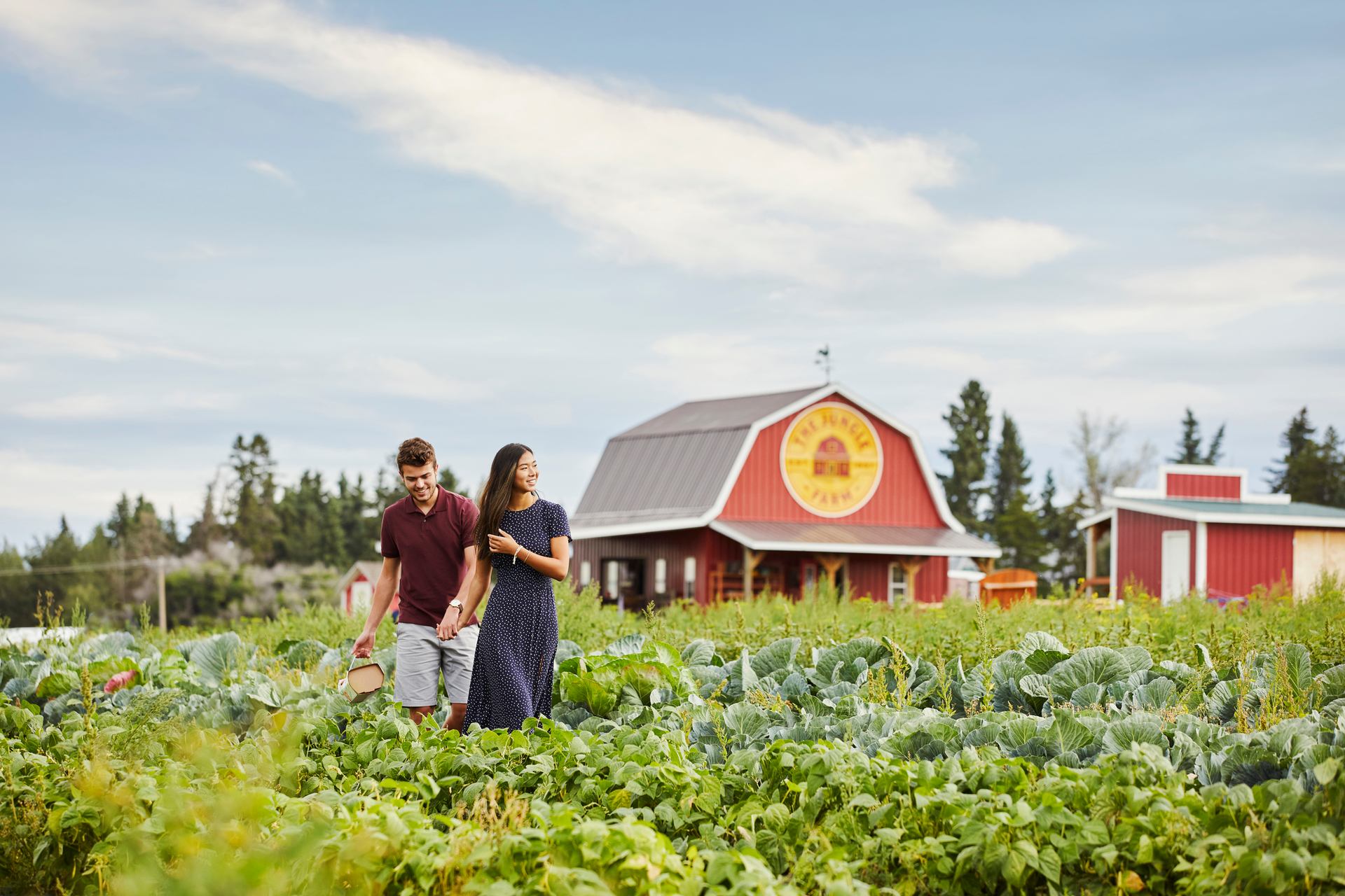 Couple walking thorugh a garden at the Jungle Farm in Red Deer