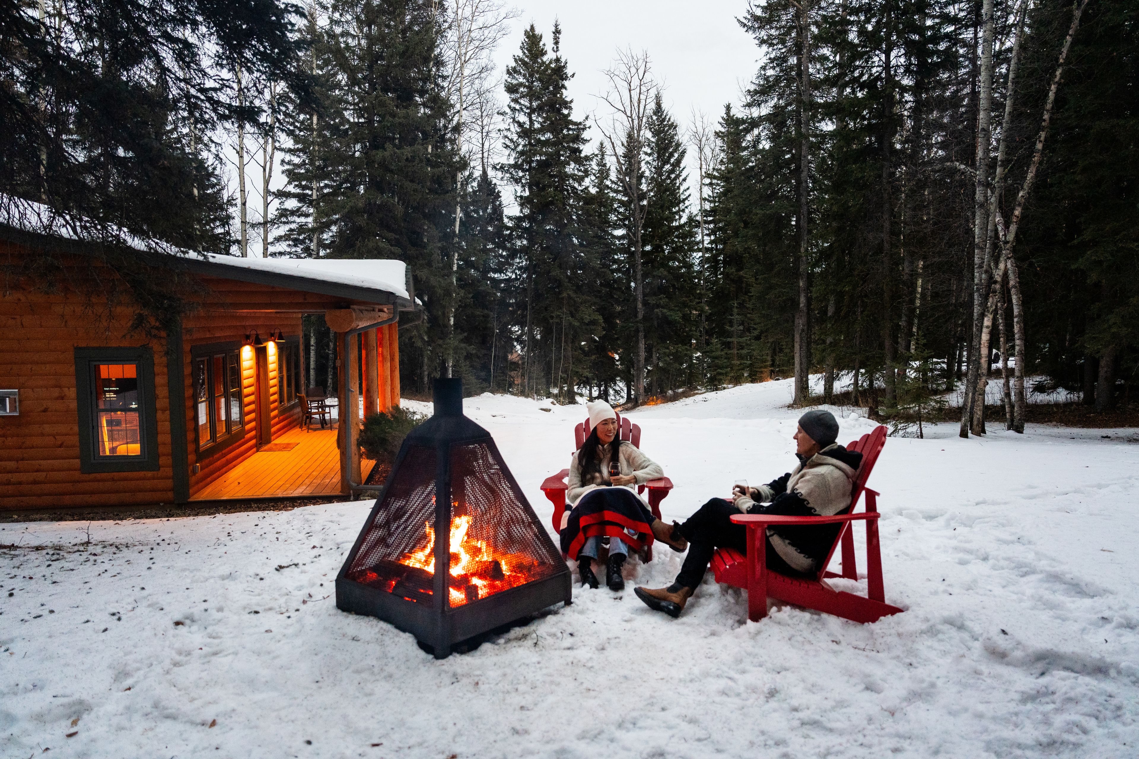 Couple enjoying the outdoor fireplace at the Prairie Creek Inn