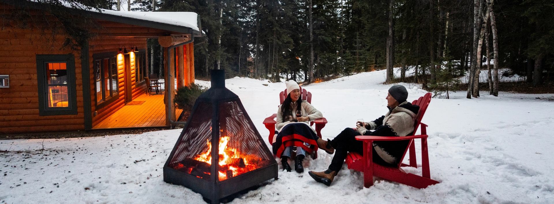 Couple enjoying the outdoor fireplace at the Prairie Creek Inn