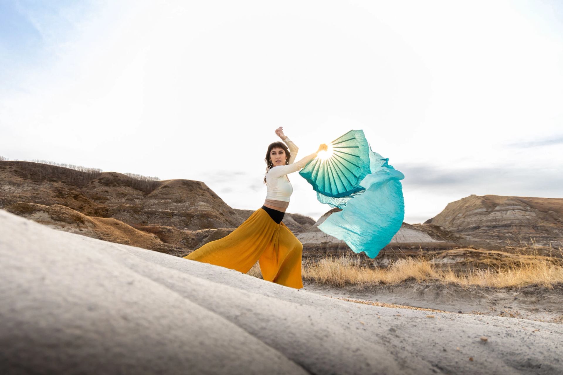 An Indigenous dancer in hoodoos.