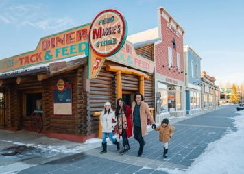 Family walking in front of Maggie Diner in High River