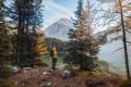 A hiker enjoys a view of a lake.