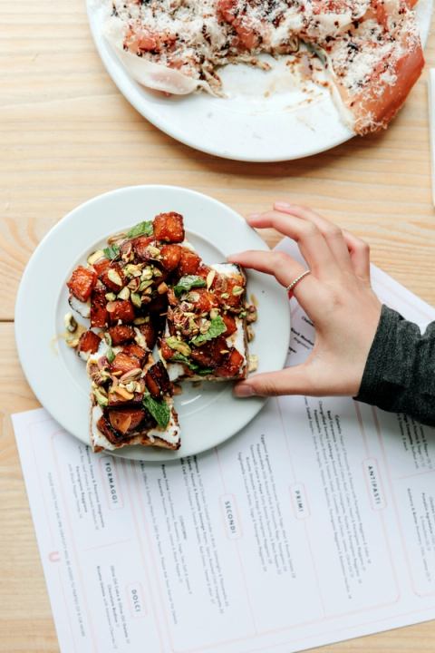 Stylized food shot of a lady eating at a restaurant