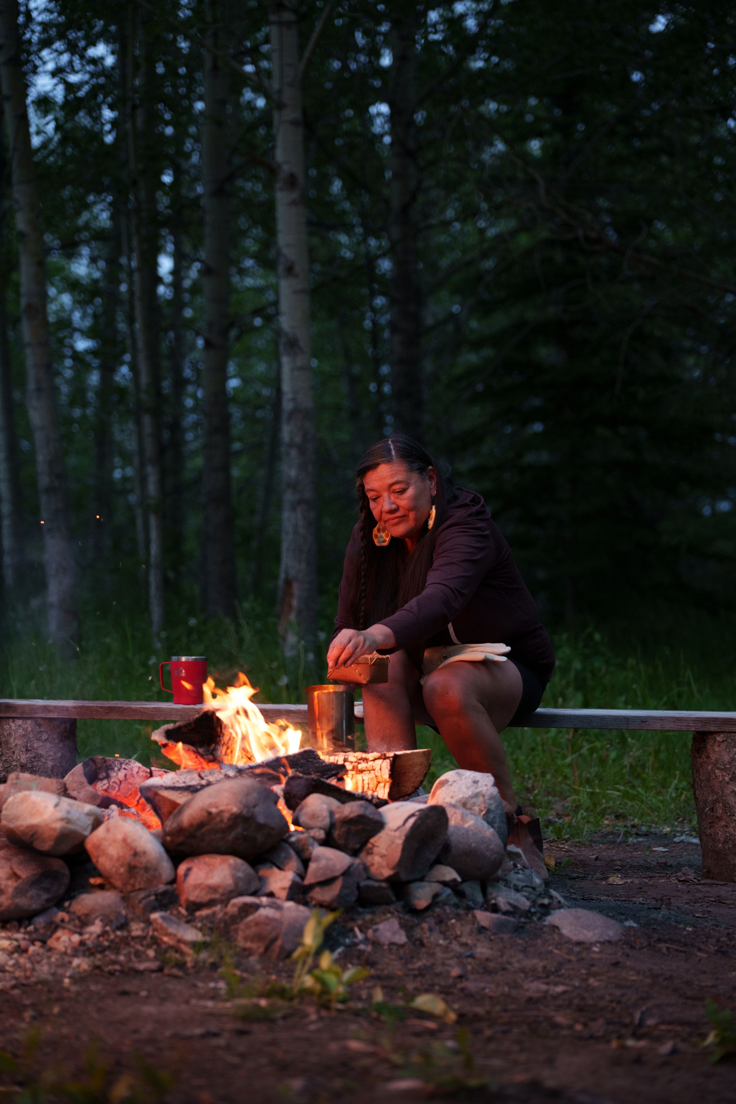 Matricia Bauer tends a firepit in Jasper.