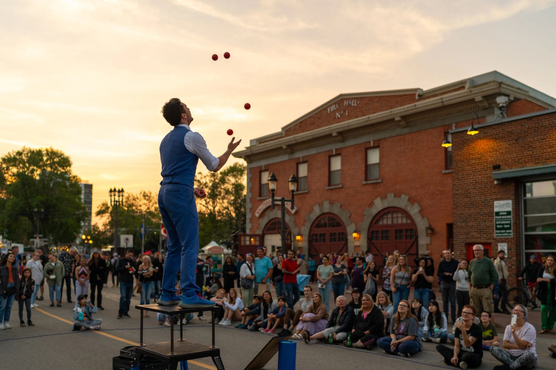 A juggler performs outdoors for a crowd at the Edmonton Fringe Festival.