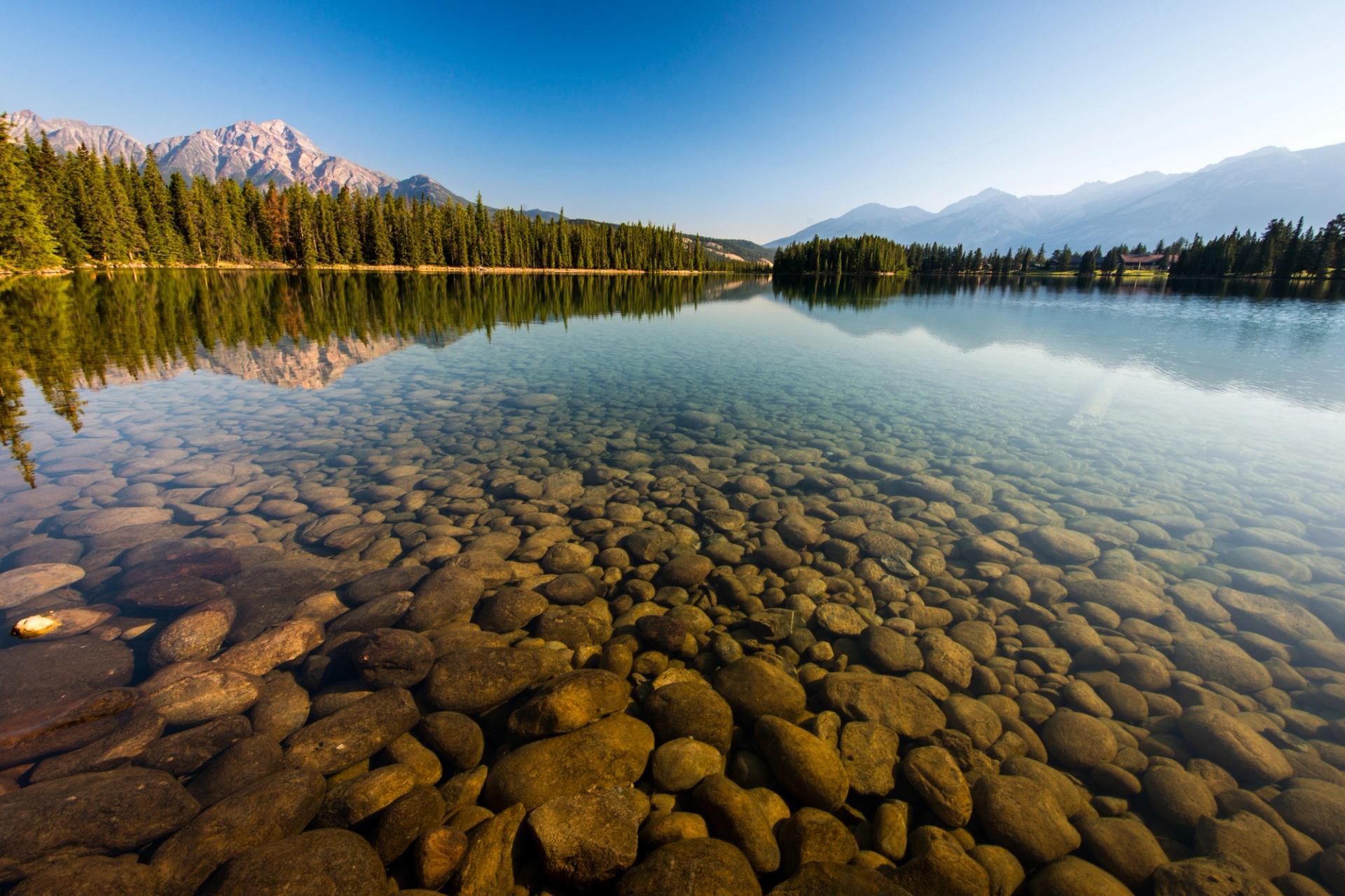 Scenic view of submerged rocks in the clear waters of Lac Beauvert in Jasper National Park