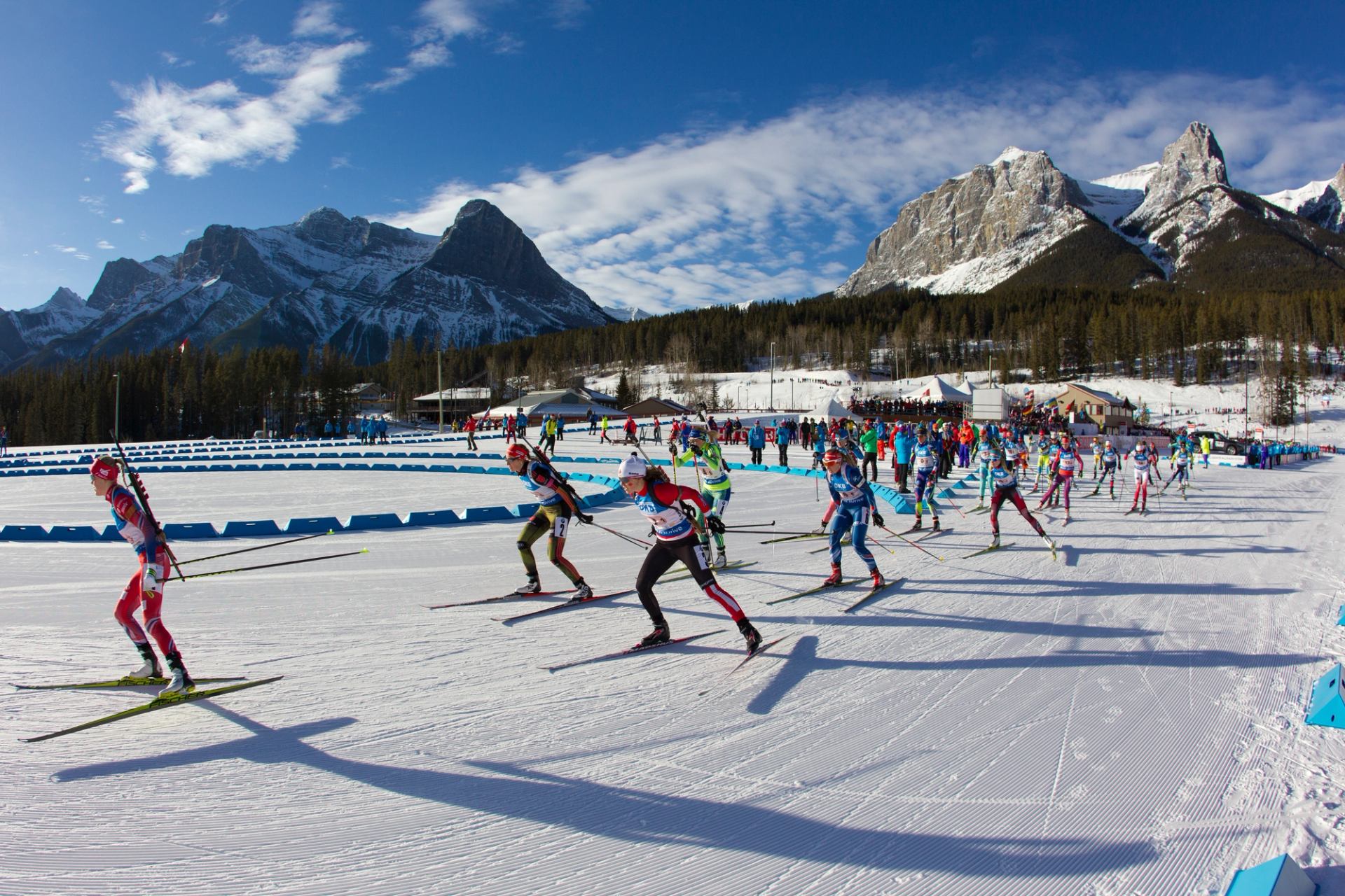 Athletes cross-country ski near the start of the Biathlon World Cup at the Canmore Nordic Centre.