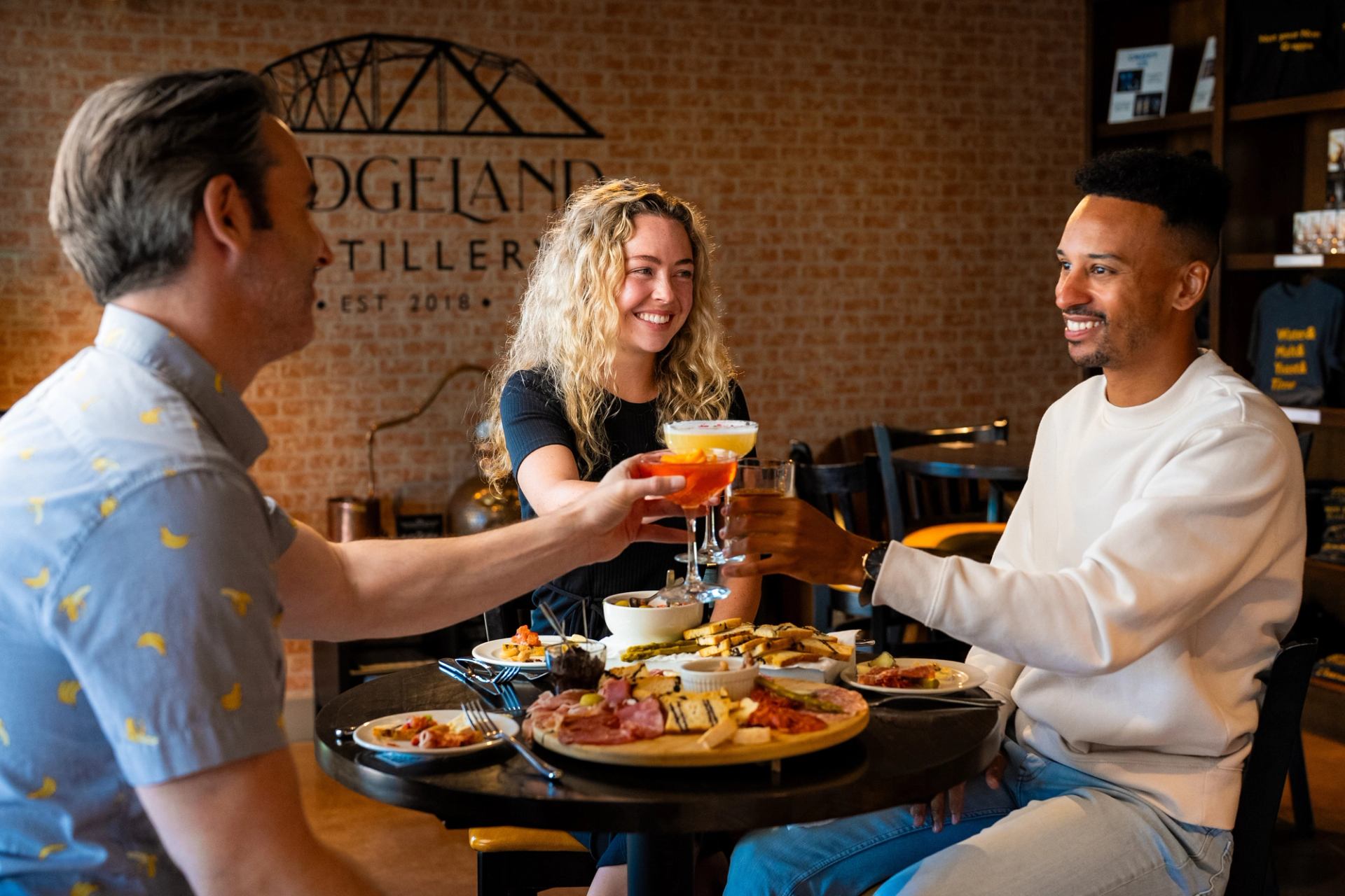 People enjoying food and beverages at Bridgeland Distillery