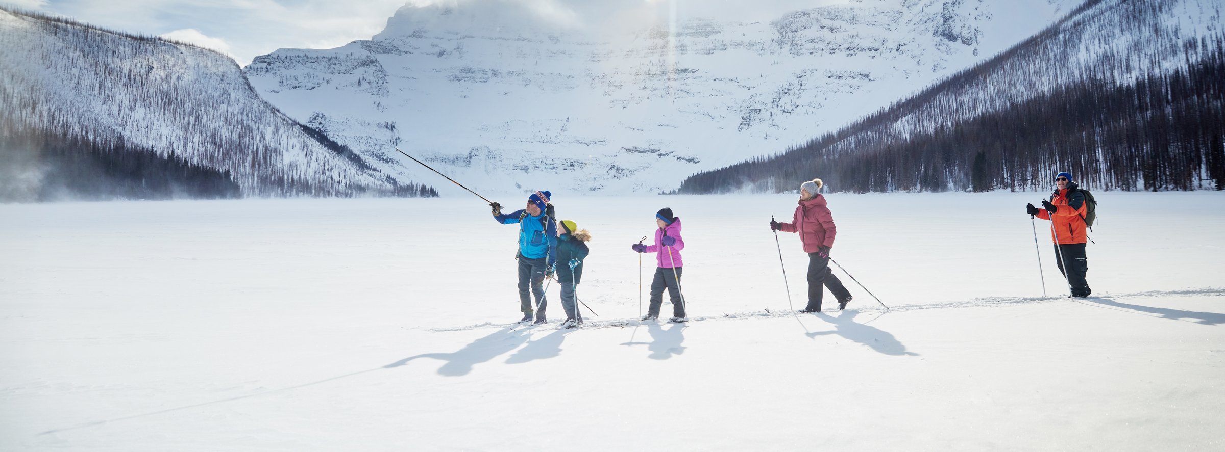 A group out snowshoeing on a frozen lake.