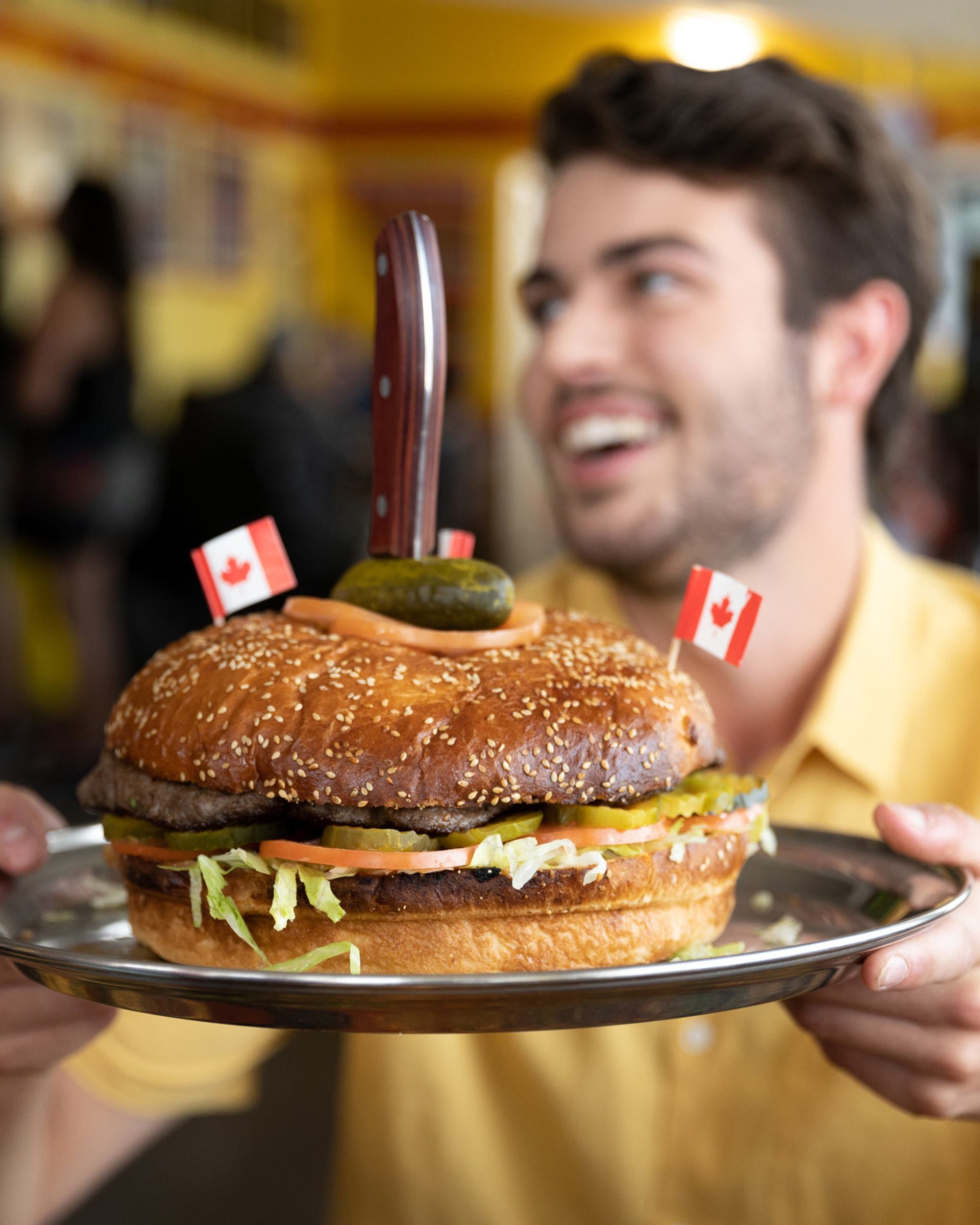 Person enjoying a burger at Bernie & The Boys Bistro in Drumheller