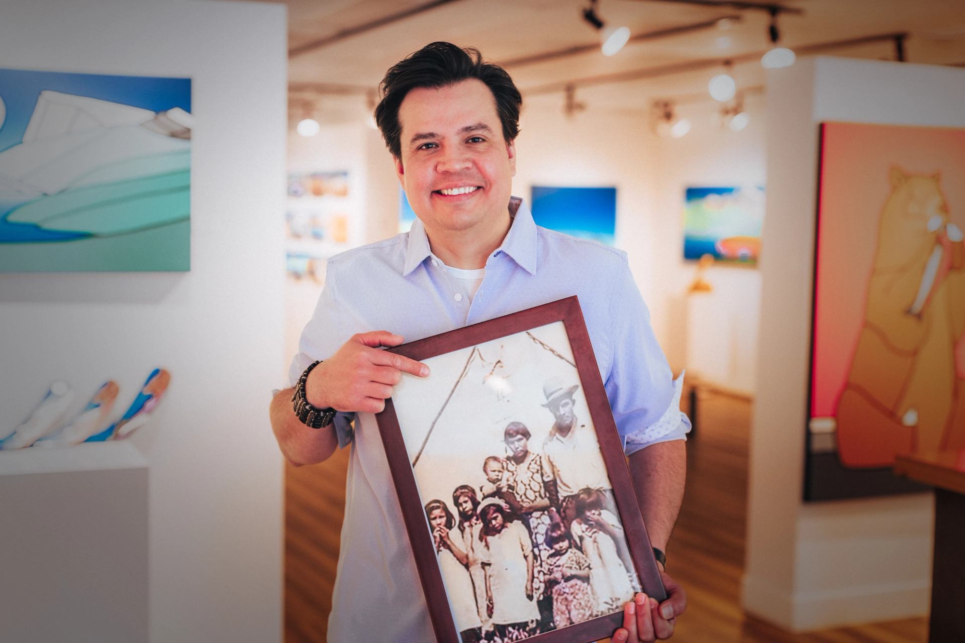 A man holding a framed picture.