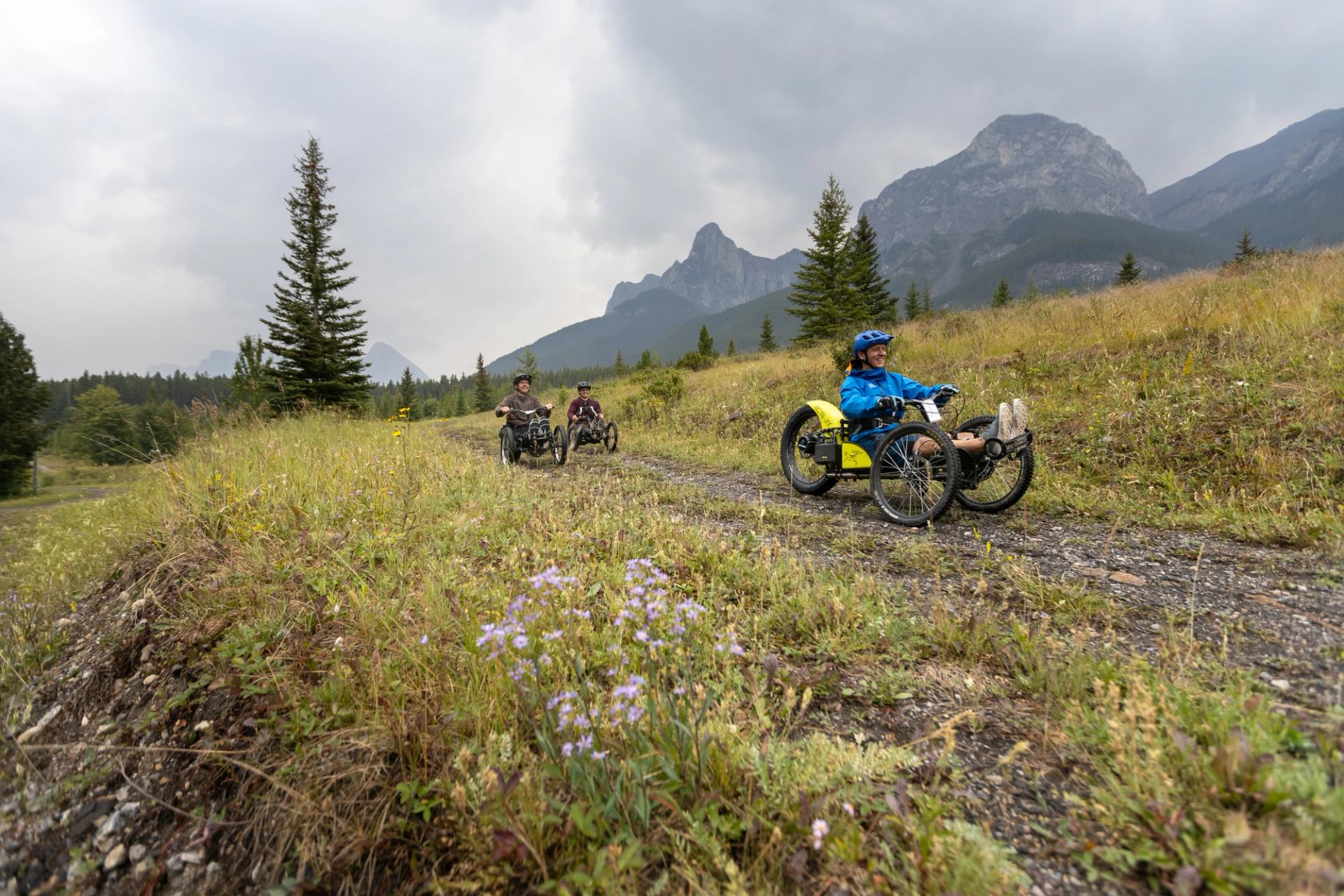 Three people Bowhead mountain biking at Canmore Nordic Centre.