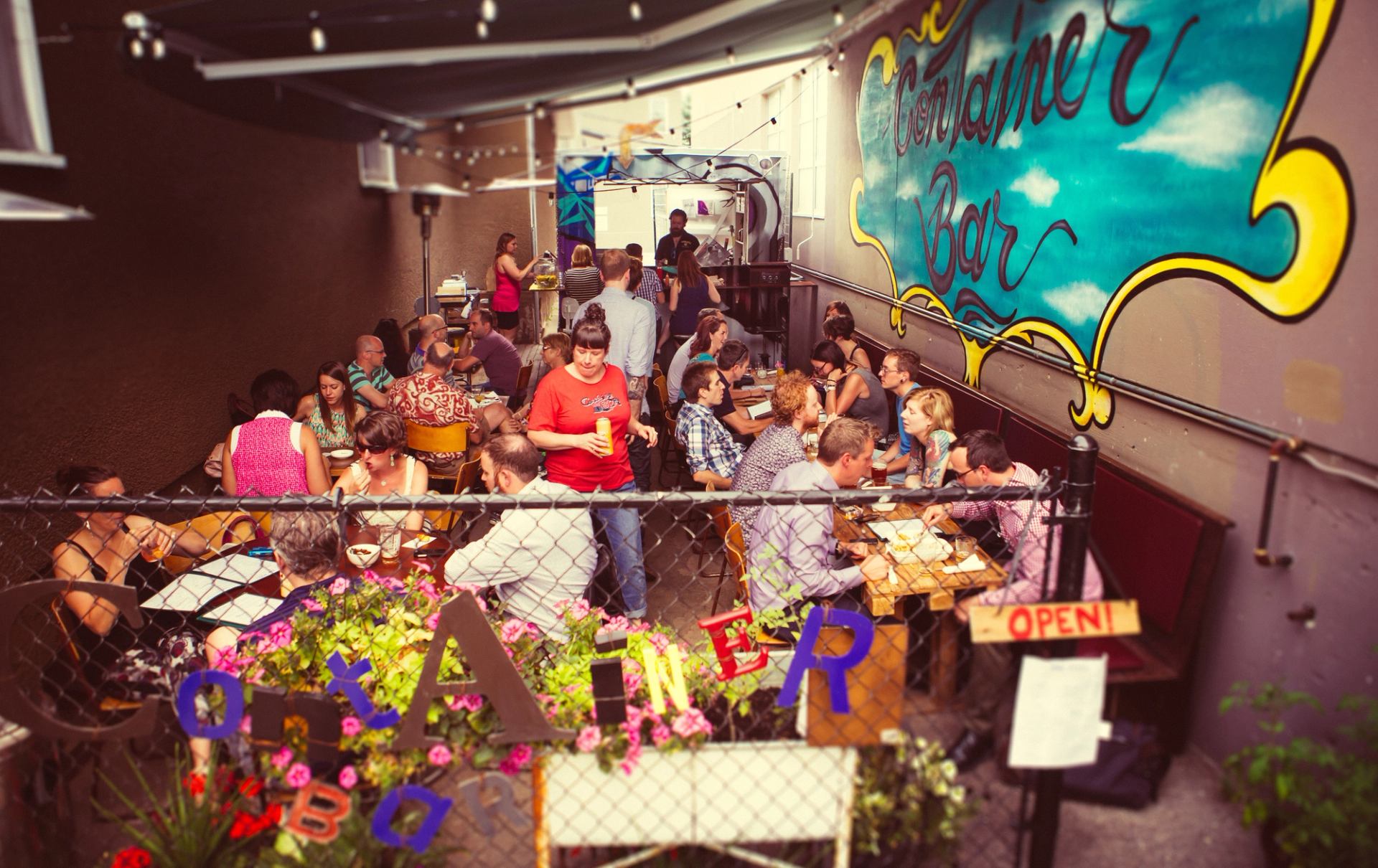 People drink and eat outside at Container Bar, a patio wedged between buildings, in the Kensington neighbourhood in Calgary.