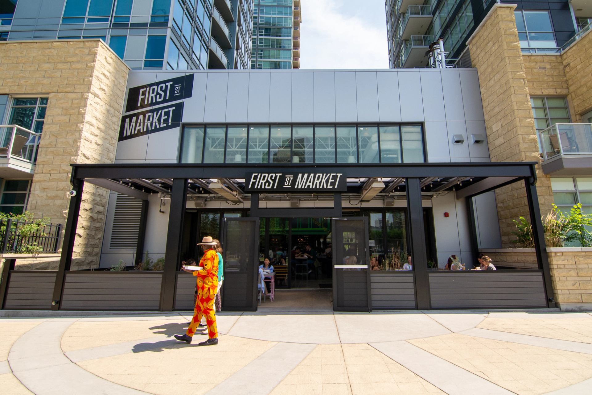 People walking in front of First Street Market in Calgary.