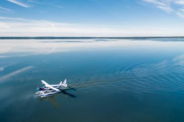 Float plane landing on lake.