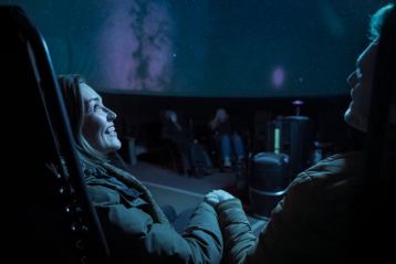 Couple viewing projected sky at the Jasper Planetarium