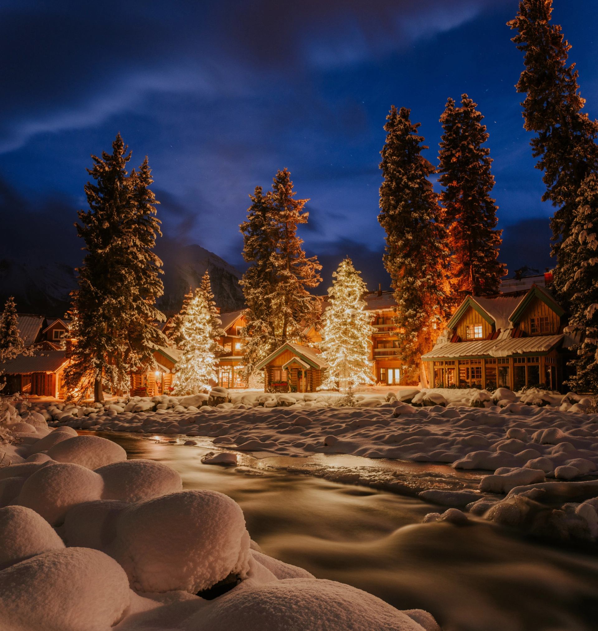 Christmas lights shine on the snow-capped Post Hotel in Lake Louise Village in Banff National Park.