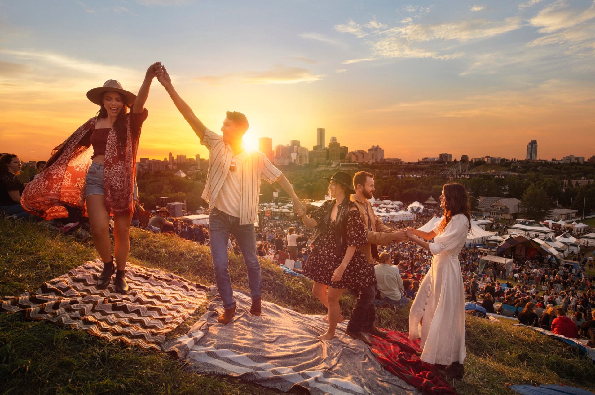 Friends dancing at dusk at the Edmonton Folk Festival