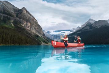 A couple canoeing at Lake Louise in Banff National Park.