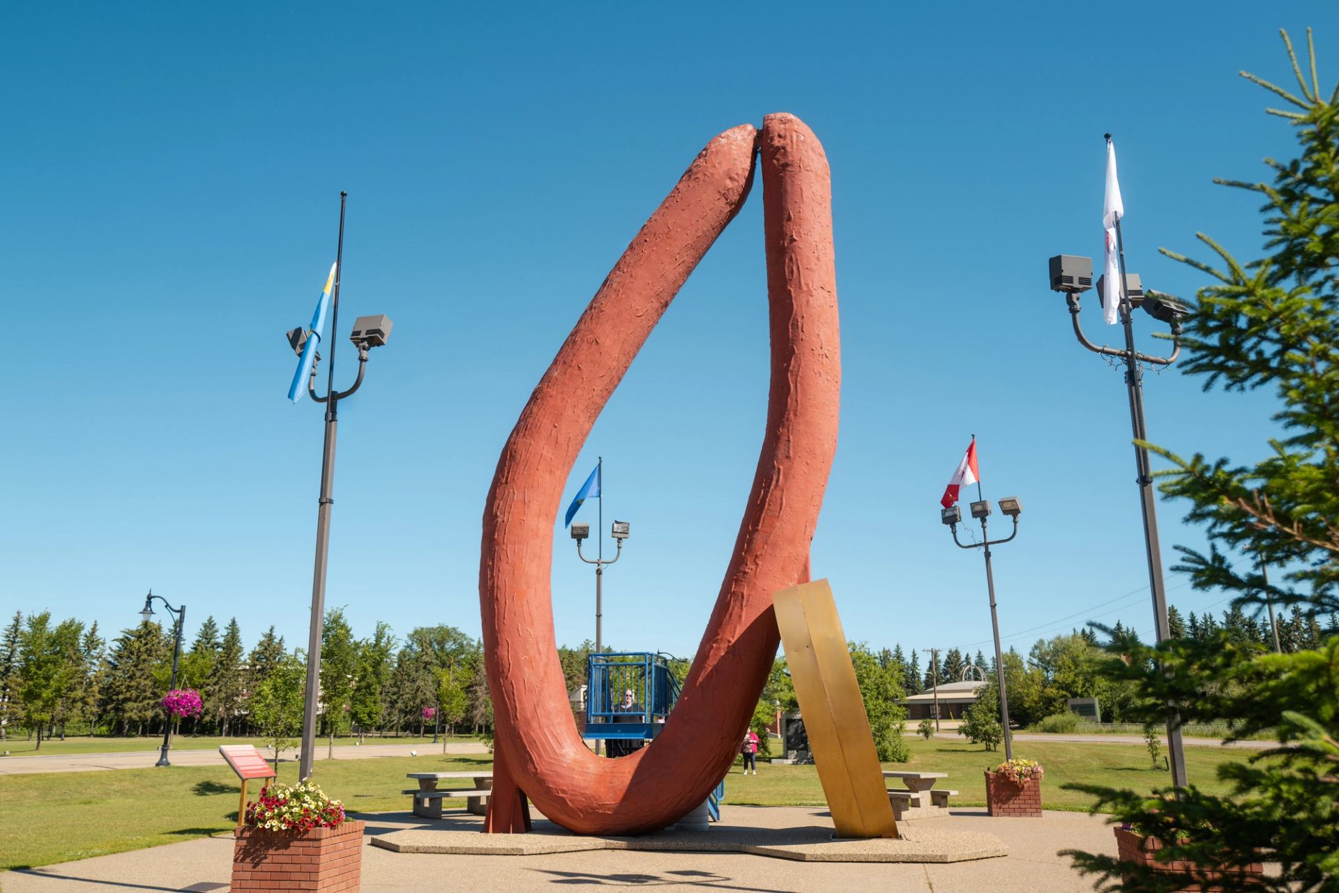 Mundare Sausage statue with sitting area.