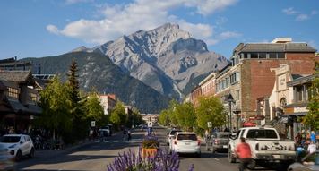Banff Ave showing traffic and Cascade Mountain in background