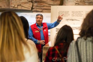 Guide giving information at Head-Smashed-In Buffalo Jump. (UNESCO-designated World Heritage Site)