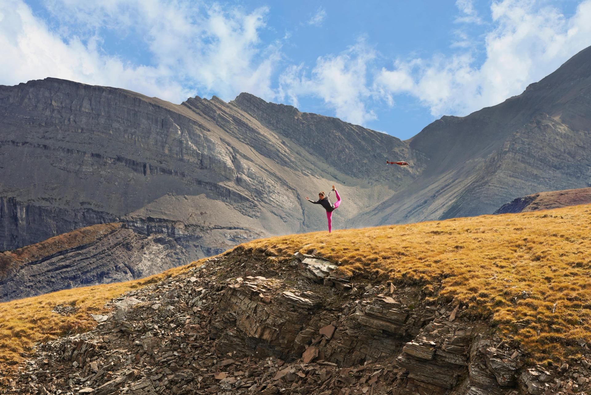 Female doing yoga in front of mountains