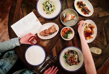 Stylized food shot with two diners.