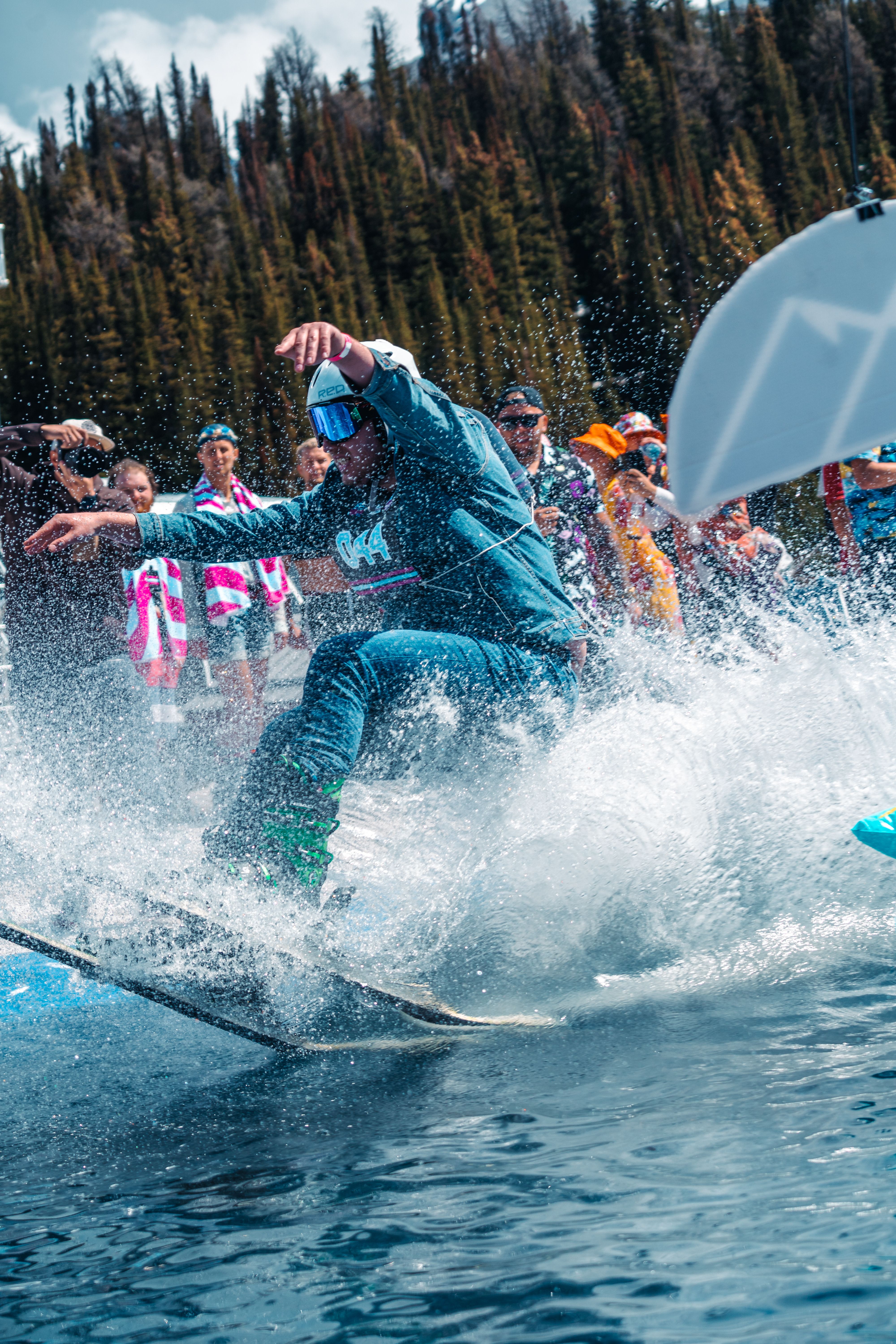 A skier skims across water during Slush Cup at Banff Sunshine Village.