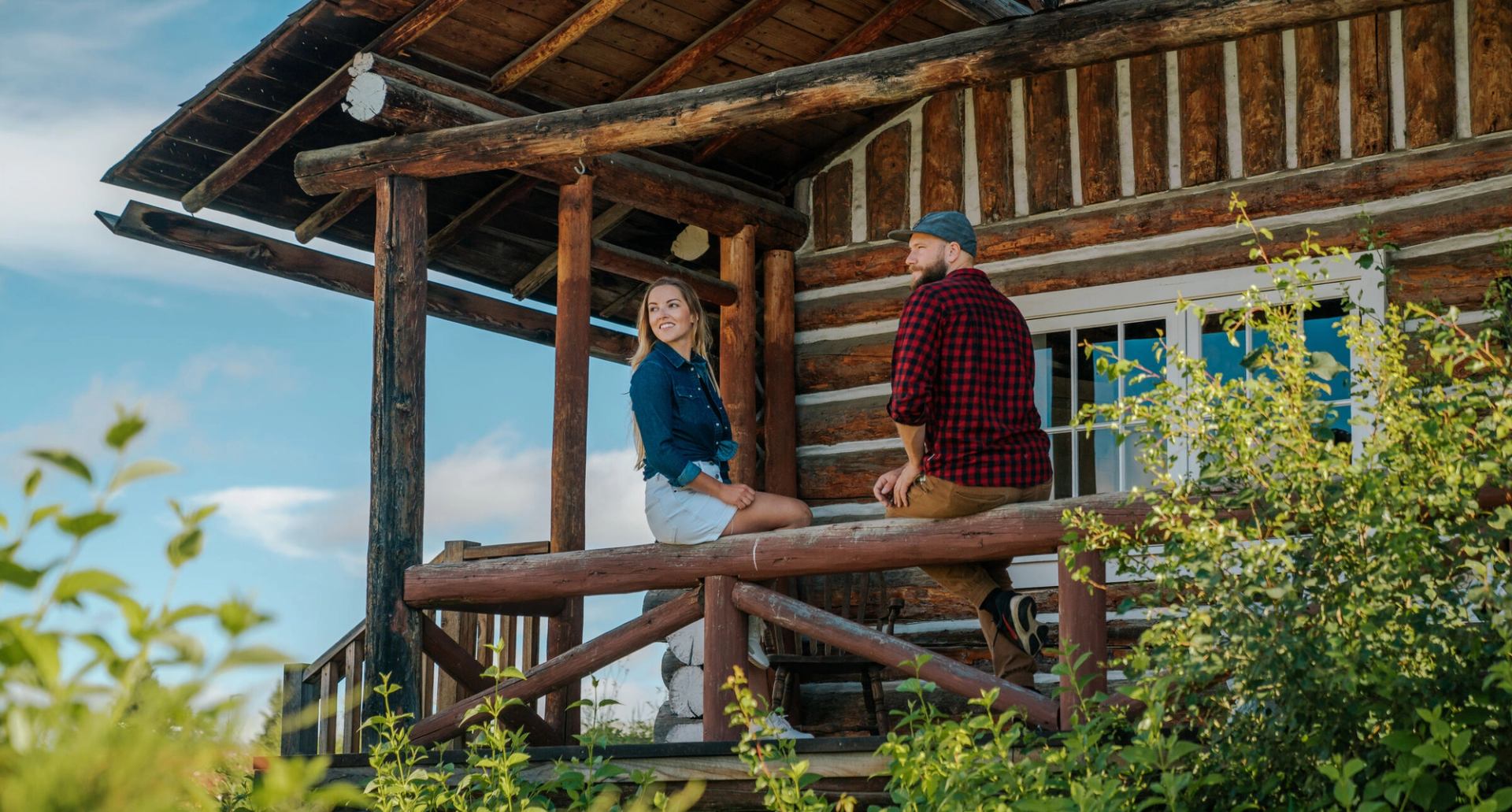 A couple sit on a deck at a lodge outside Fort McMurray.