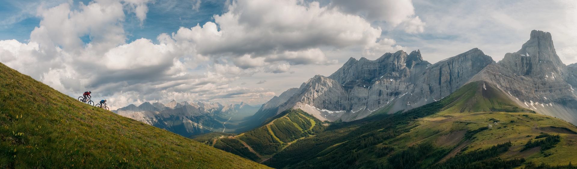 Pano shot of 2 Mountain Bikers riding down Fortress Mountain