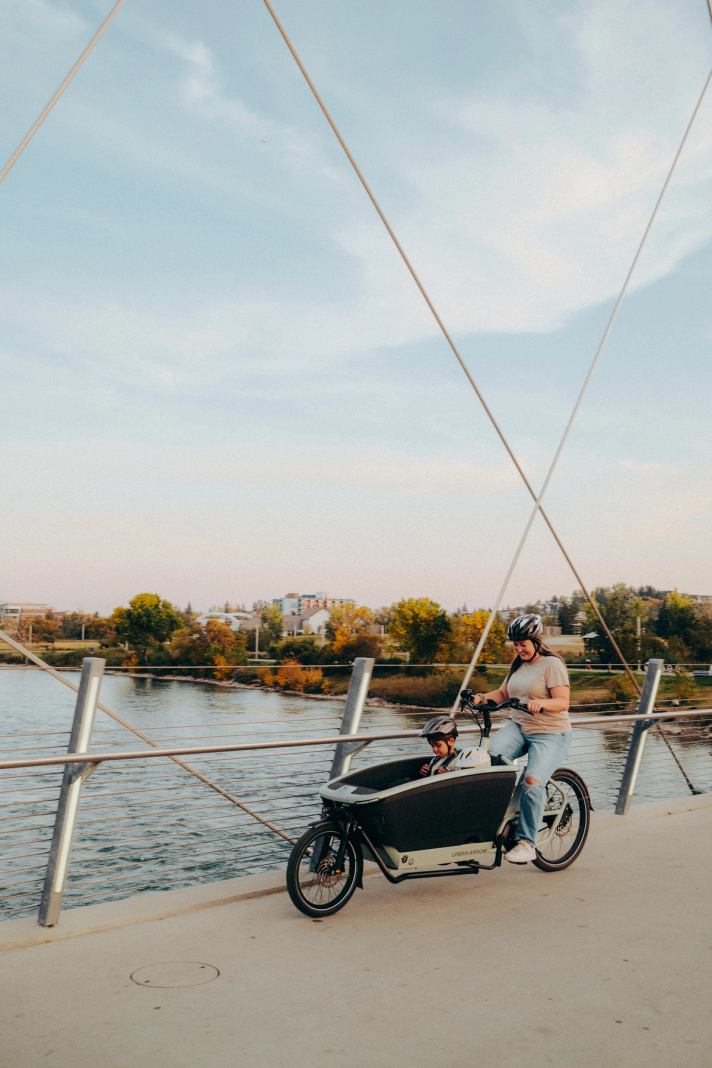 A family Cargo Biking in fall in Calgary.