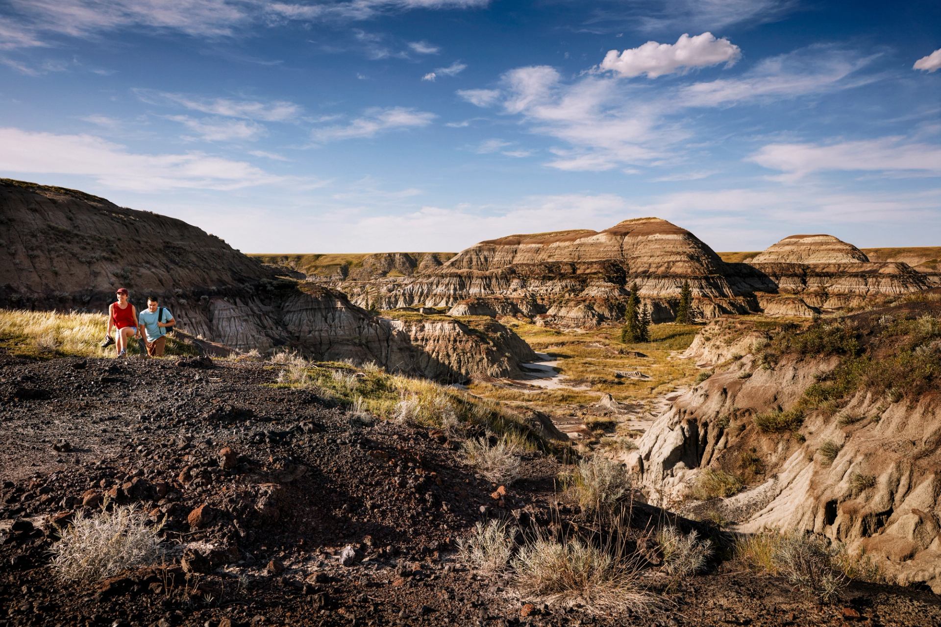 Couple taking a rest on their hike through Horseshoe Canyon in the Canadian Badlands.