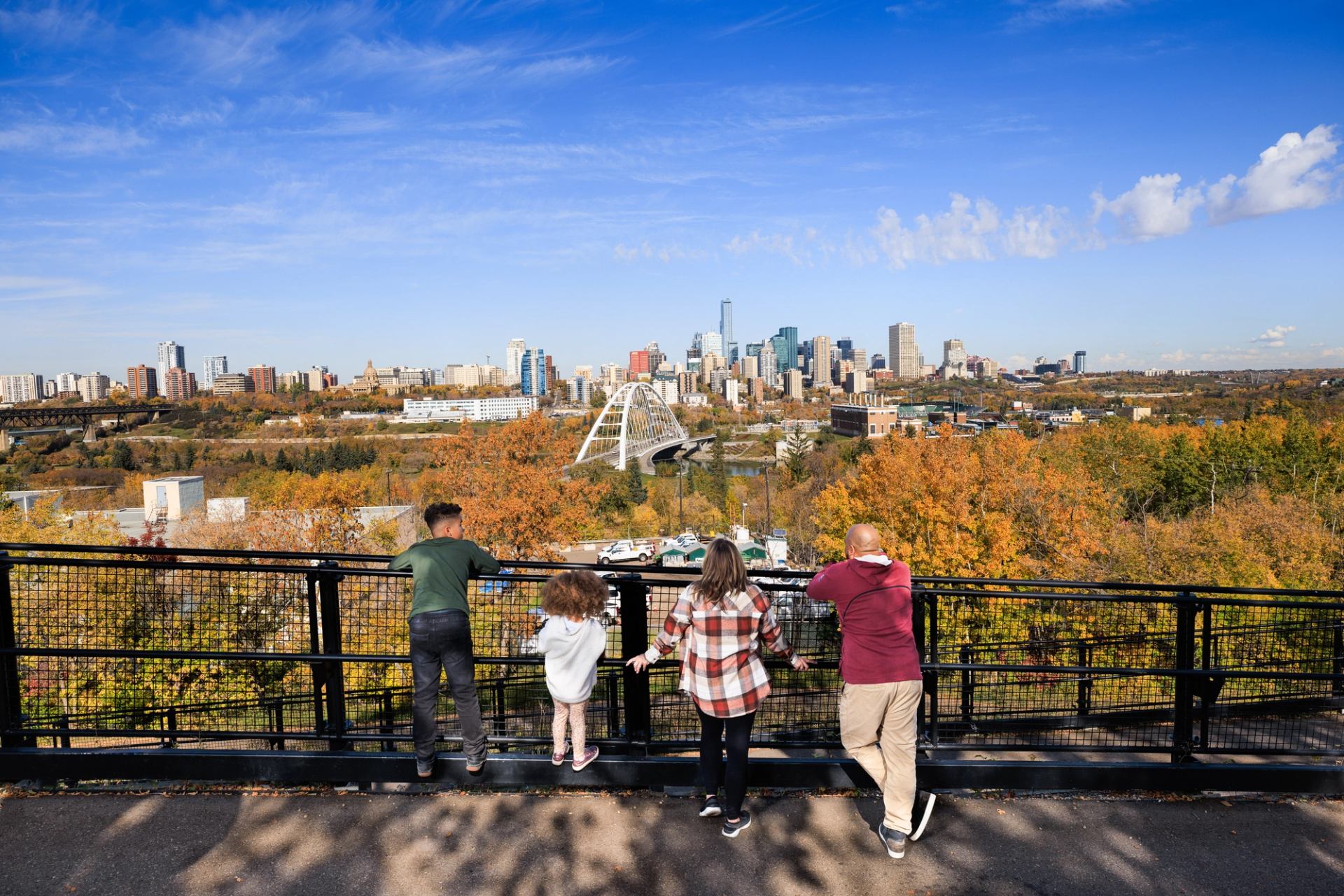 A family looks out over the colourful Edmonton River Valley.