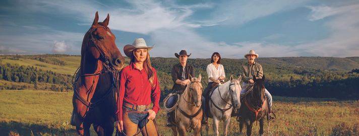 Cast of CBC's Heartland standing in the Foothills of Alberta.