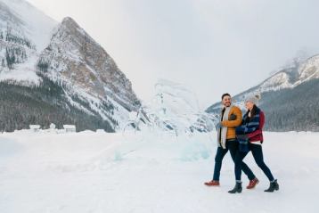 Couple walking along at the Ice Magic Festival at Lake Louise in Banff National Park