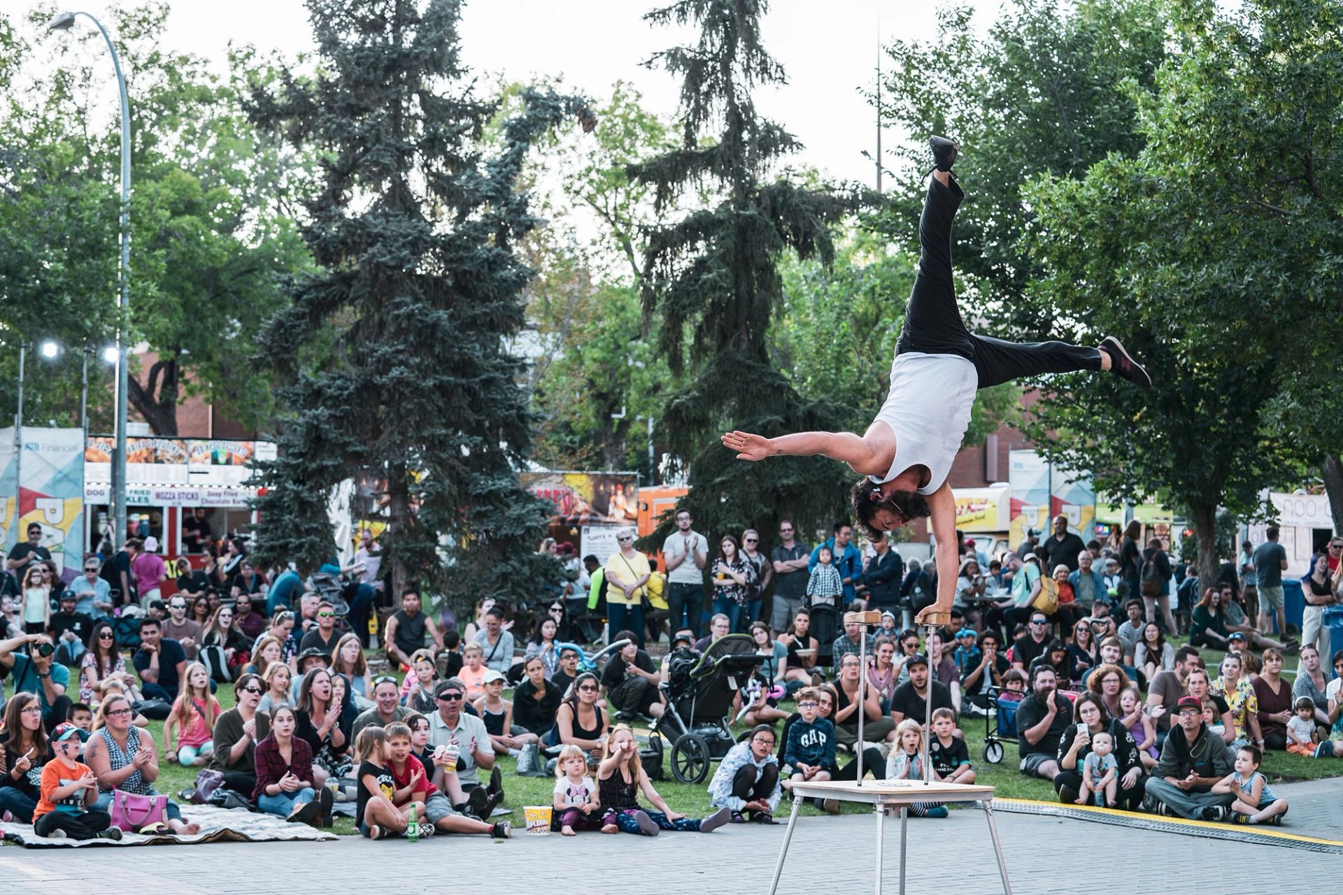 A performer on stage in front of a large crowd at Edmonton International Fringe Festival.