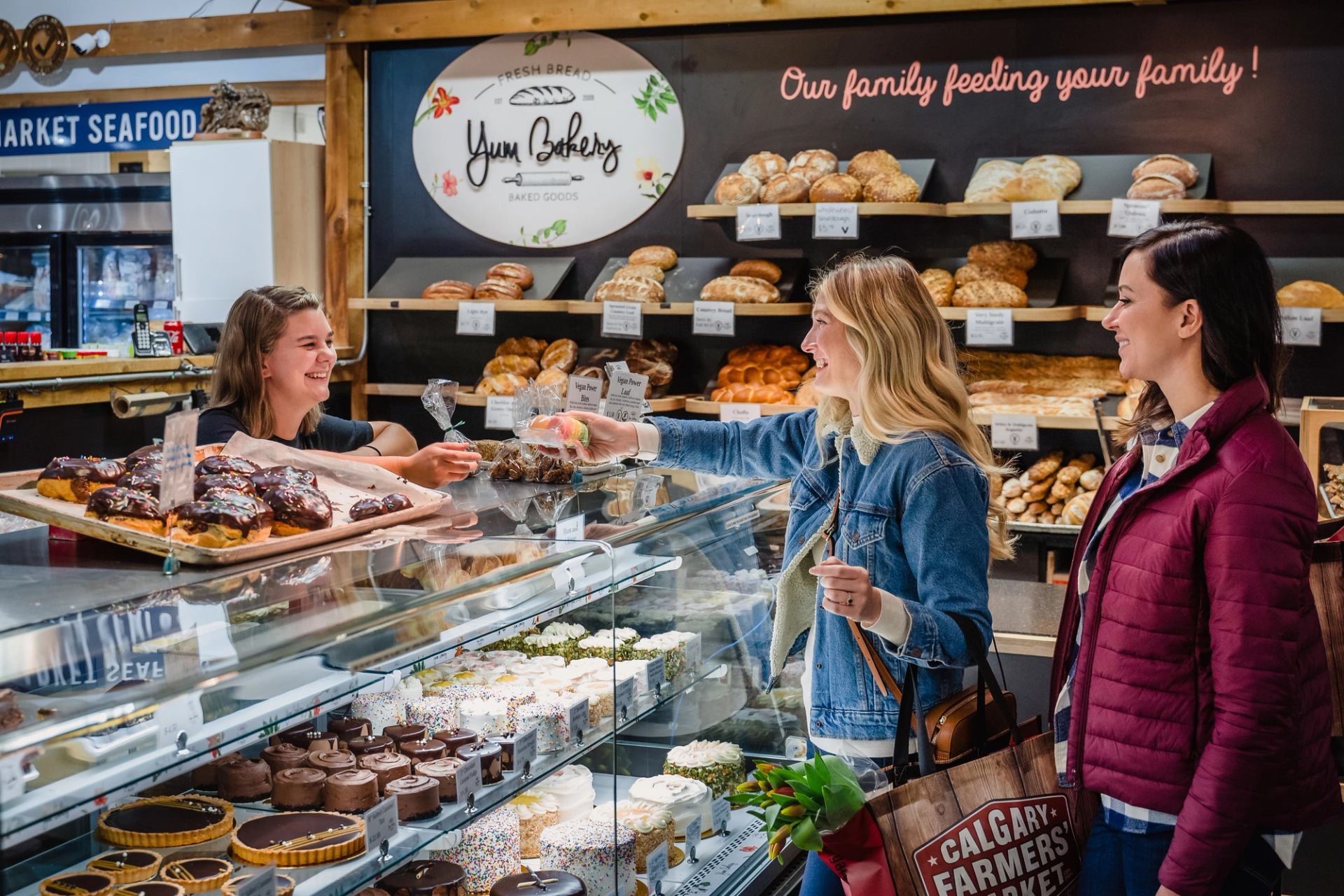 Friends shopping at a bakery the Calgary Farmers Market