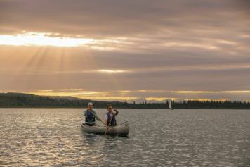 People canoeing during sunset