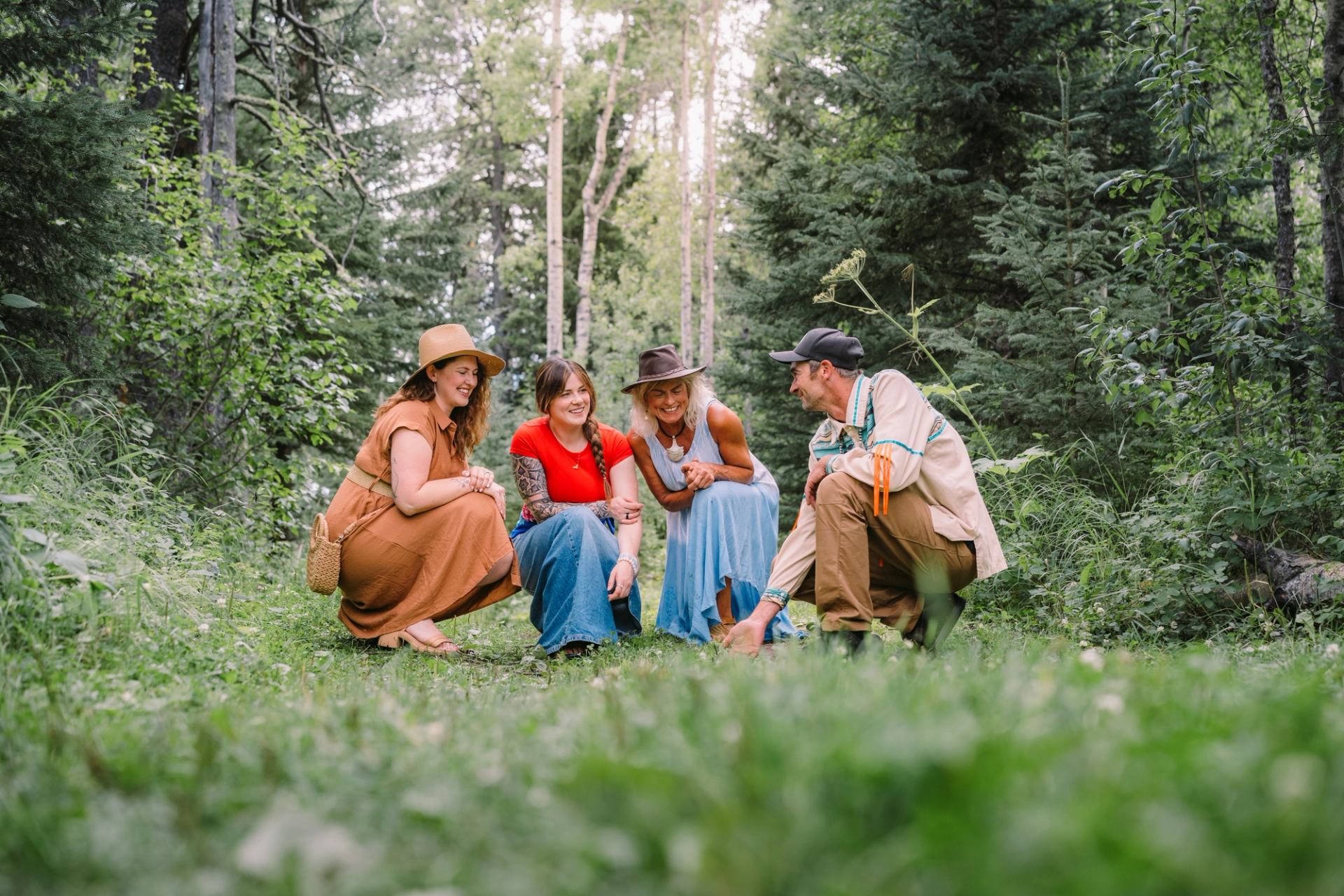 Three guests learn about Indigenous medicines on a medicine walk at Mahikan Trails.