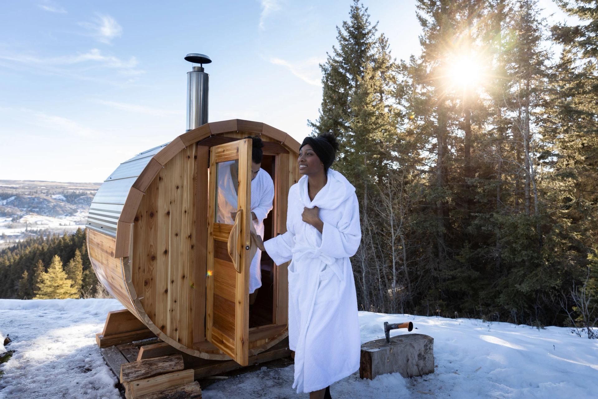 A couple exiting the sauna at Running Reins Ranch in the winter.