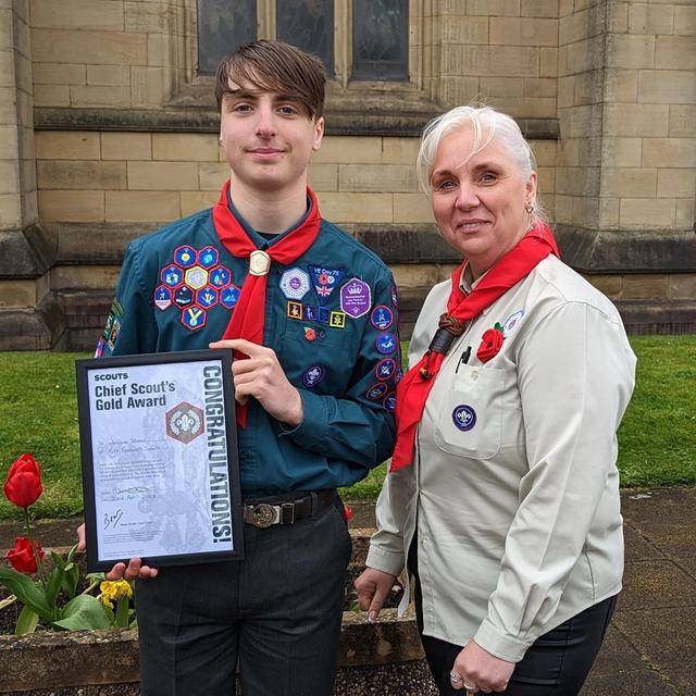 Bee Stones and a scout receiving their gold award