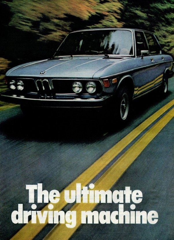 Vintage BMW 3 Series sedan in navy blue, cruising on a highway with 'The Ultimate Driving Machine' slogan below, evoking a sense of classic luxury and performance.