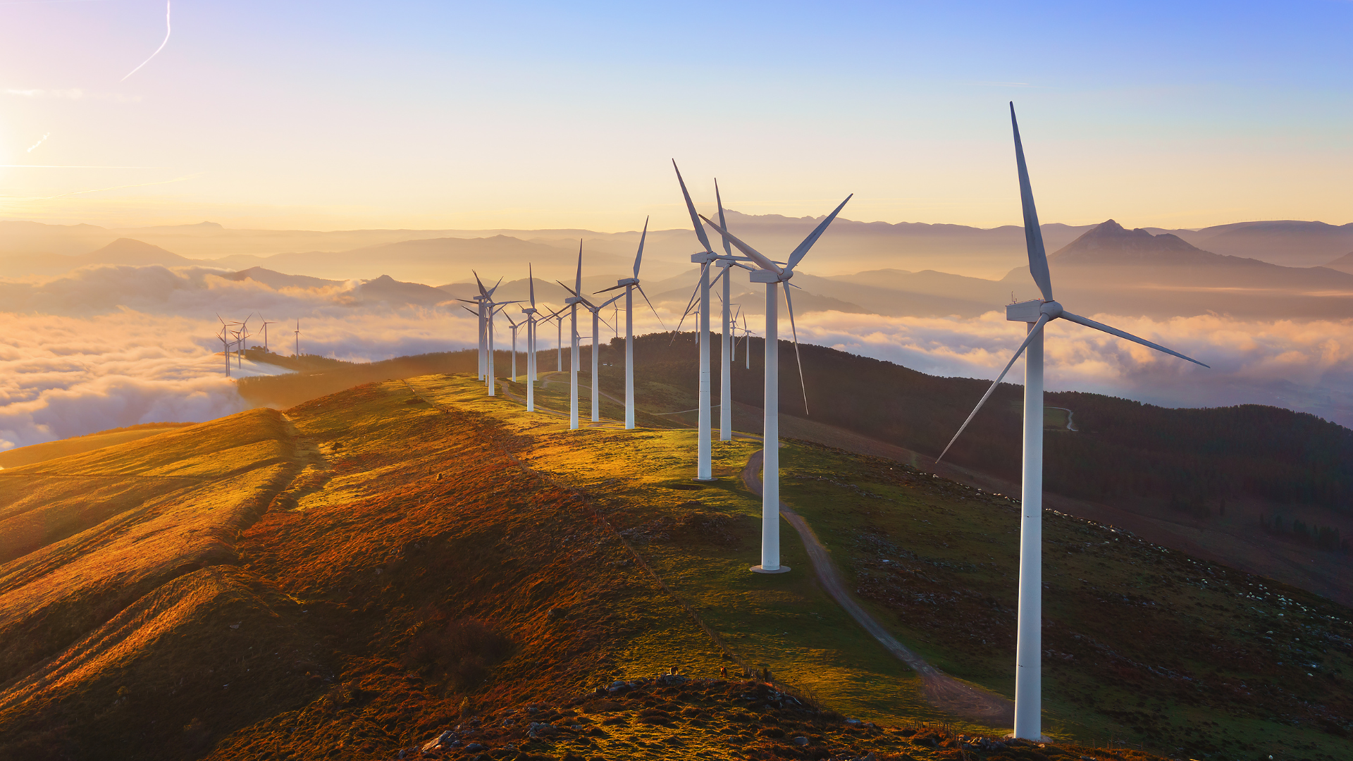 Wind turbines in a mountainous landscape illustrating real-time energy data and smart meter use cases.