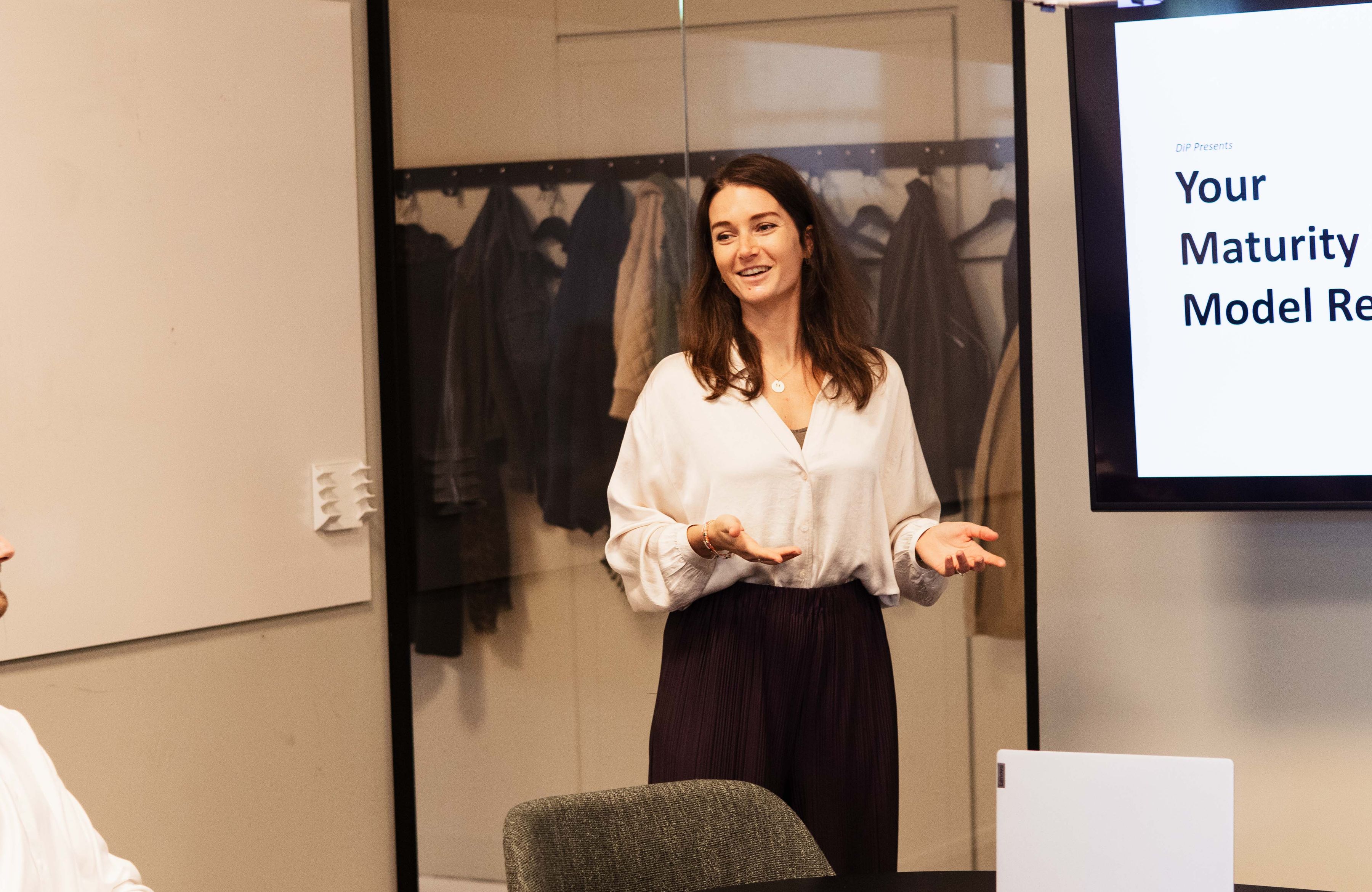 a strategy and transformation consultant giving a presentation to a group of stakeholders