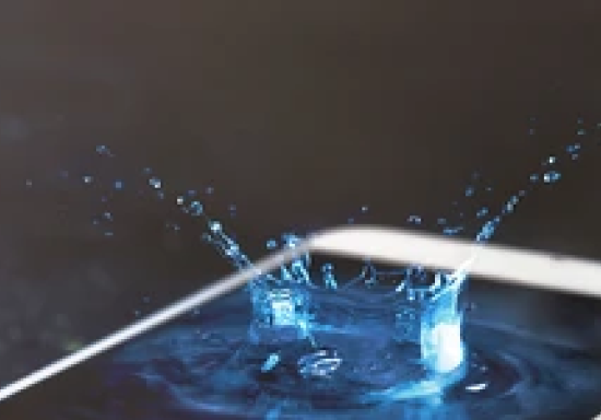 Phone with water splashing on screen