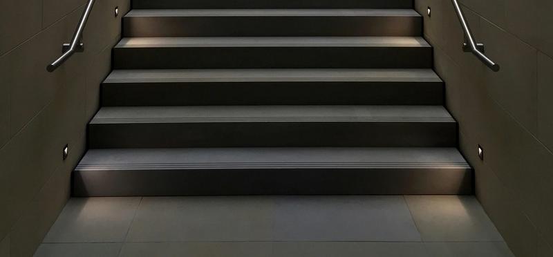 a perspective standing on the flat section of a staircase looking up